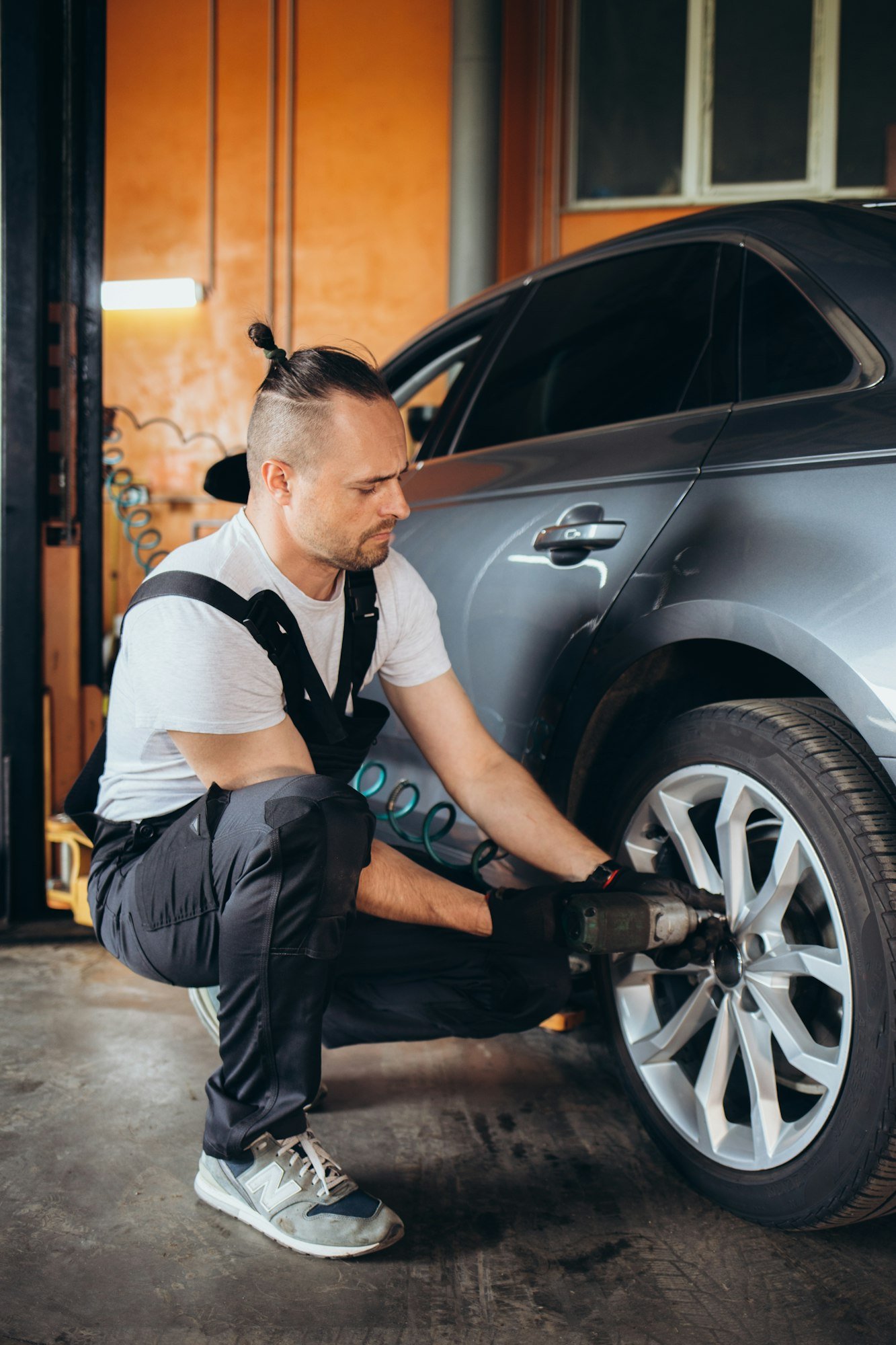 Maintenance male checking tire service via insurance system at garage, Safety vehicle to reduce